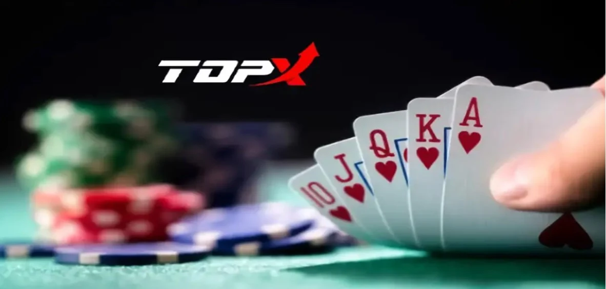 Mão com cartas de pôquer e fichas ao fundo, imagem da TopX